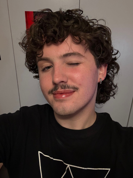 Image may contain Head Person Face Body Part Neck Adult Curly Hair and Hair